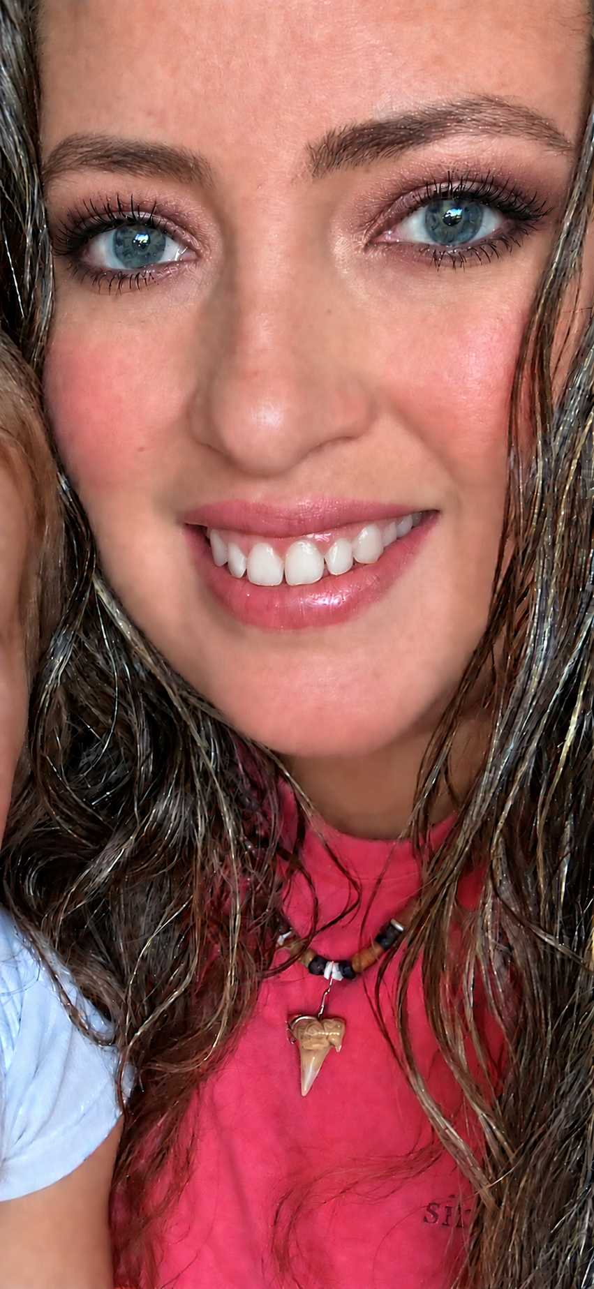 Maria Ellis smiling in a portrait with smoky eye makeup